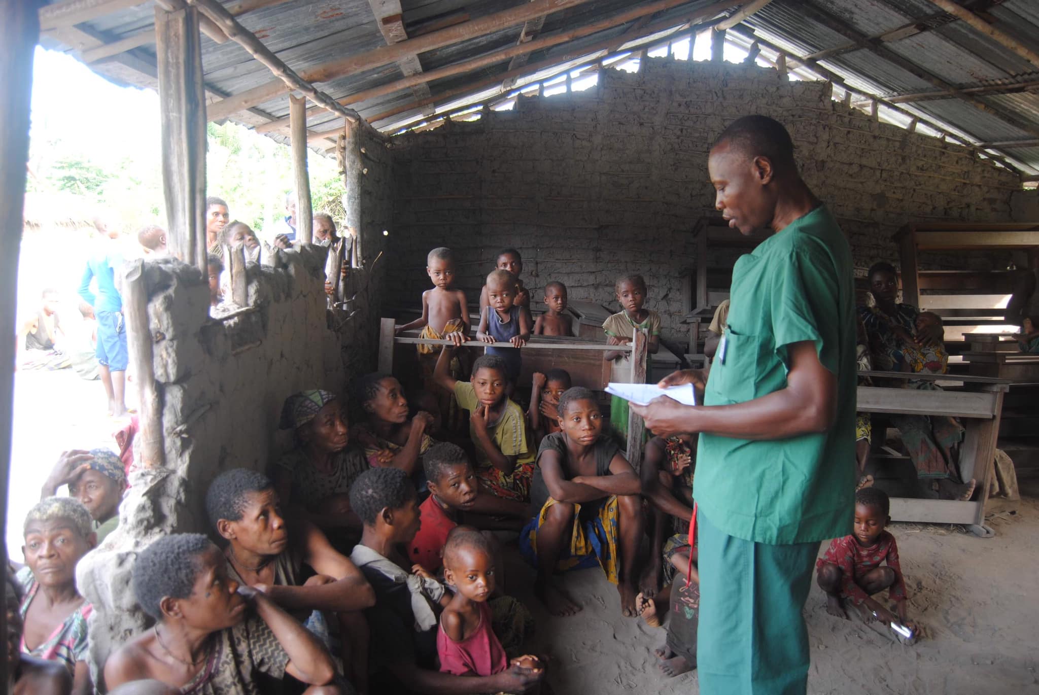 Missionary nurse sharing a Bible Story with Women and Children